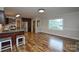Open concept living and dining area with hardwood floors and stainless steel appliances in the kitchen at 1506 Cameron Dr, Statesville, NC 28625