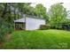 Outbuilding featuring green grass, mature trees, and a covered area to park your car at 1506 Cameron Dr, Statesville, NC 28625