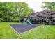 Backyard playground area featuring a playset, swings, slide, and safety surface at 1506 Cameron Dr, Statesville, NC 28625