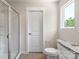 Modern bathroom featuring a glass-enclosed shower and toilet, complemented by sleek fixtures and natural light at 1508 Doran Ter, Richburg, SC 29729