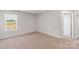Neutral carpeted bedroom with a large window and a white door at 1508 Doran Ter, Richburg, SC 29729
