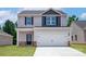 Charming two-story home with a modern design, attached two-car garage, and well-manicured lawn at 1508 Doran Ter, Richburg, SC 29729