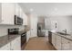 Modern kitchen featuring stainless steel appliances, granite countertops, and white cabinets at 1508 Doran Ter, Richburg, SC 29729