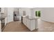 Kitchen island featuring stainless steel dishwasher, white cabinets, and granite countertops at 1508 Doran Ter, Richburg, SC 29729