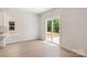 Bright living room with hardwood floors, a window, and a sliding glass door that leads to the backyard at 1508 Doran Ter, Richburg, SC 29729
