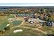 Expansive aerial view showcases a clubhouse, tennis courts, golf course, and the surrounding community by the water at 17308 Players Ridge Dr, Cornelius, NC 28031