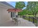 Enjoy outdoor dining on this back deck featuring an umbrella, table, and chairs with backyard views at 17308 Players Ridge Dr, Cornelius, NC 28031
