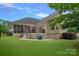 Large backyard showcasing lawn, patio, screened porch, and deck, perfect for outdoor living at 17308 Players Ridge Dr, Cornelius, NC 28031