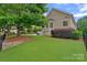 Backyard with verdant lawn, mature trees, and landscaping that offers privacy and natural beauty at 17308 Players Ridge Dr, Cornelius, NC 28031