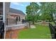 The house boasts a beautiful backyard with well-maintained lawn, landscaping, and deck at 17308 Players Ridge Dr, Cornelius, NC 28031