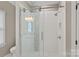 Shower with glass door and white tile, and featuring modern fixtures and finishes at 17308 Players Ridge Dr, Cornelius, NC 28031
