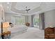Spacious bedroom with a tray ceiling, neutral carpet, and access to a balcony at 17308 Players Ridge Dr, Cornelius, NC 28031