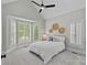 Spacious bedroom with a tray ceiling, neutral carpet, lots of light, and a sitting area at 17308 Players Ridge Dr, Cornelius, NC 28031