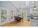 Well-lit breakfast nook with hardwood floors, white trim, and a view of the backyard at 17308 Players Ridge Dr, Cornelius, NC 28031