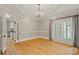 Dining room with tray ceiling, chandelier, and natural light at 17308 Players Ridge Dr, Cornelius, NC 28031