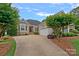 Charming home featuring a well-maintained lawn and a welcoming driveway at 17308 Players Ridge Dr, Cornelius, NC 28031