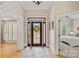 Inviting foyer with a decorative front door, hardwood floors, and elegant lighting at 17308 Players Ridge Dr, Cornelius, NC 28031