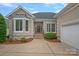 Charming front entrance with beautiful door, manicured landscaping, and attached garage for modern living at 17308 Players Ridge Dr, Cornelius, NC 28031