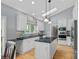 Modern kitchen with white cabinets, stainless steel appliances, and a center island at 17308 Players Ridge Dr, Cornelius, NC 28031