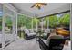 Inviting screened porch with comfortable seating and views of the landscaped backyard at 17308 Players Ridge Dr, Cornelius, NC 28031