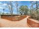 Curved wooden boardwalk winding through lush trees, providing a picturesque walking path in the community at 17436 Hawks View Dr, Indian Land, SC 29707