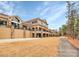 Upscale multi-story building with stone accents, arched entryways, and manicured lawn and a walking trail at 17436 Hawks View Dr, Indian Land, SC 29707