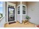 Inviting covered front porch with stylish decor and cozy bench seating at 17436 Hawks View Dr, Indian Land, SC 29707