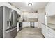 Bright kitchen with stainless steel appliances, light wood floors, white cabinetry, and granite countertops at 17436 Hawks View Dr, Indian Land, SC 29707