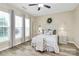 Bright bedroom featuring wood-look floors, a ceiling fan, and large windows at 17436 Hawks View Dr, Indian Land, SC 29707