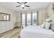 Bright bedroom featuring wood-look floors, a ceiling fan, and large windows at 17436 Hawks View Dr, Indian Land, SC 29707