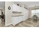 Bright pantry with white cabinetry, granite countertops, light wood floors, and sliding closet door at 17436 Hawks View Dr, Indian Land, SC 29707