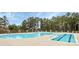 Large outdoor swimming pool with a stone accented fence and a lap swimming area at 17436 Hawks View Dr, Indian Land, SC 29707