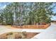 Serene walking path with wooden railings, surrounded by trees and landscaping, enhancing the community's natural beauty at 17436 Hawks View Dr, Indian Land, SC 29707