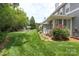 Lush backyard with a screened porch, stepping stone path and mature trees at 18840 Silver Quay Dr # 12, Cornelius, NC 28031
