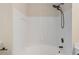 Bathroom showcasing a clean, white tiled shower-tub combination with stylish fixtures and modern design at 18840 Silver Quay Dr # 12, Cornelius, NC 28031