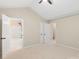 Bright, spacious bedroom with a vaulted ceiling, neutral walls, and an ensuite bathroom view from the doorway at 18840 Silver Quay Dr # 12, Cornelius, NC 28031