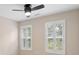 Bedroom featuring windows with plantation shutters and a modern ceiling fan with lights at 18840 Silver Quay Dr # 12, Cornelius, NC 28031