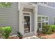 Charming front entrance with decorative columns and well-manicured landscaping at 18840 Silver Quay Dr # 12, Cornelius, NC 28031
