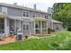 Beautiful home exterior with a screened-in porch and lush green lawn at 18840 Silver Quay Dr # 12, Cornelius, NC 28031