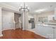 Open concept kitchen with stainless steel appliances, white cabinets, and hardwood floors at 18840 Silver Quay Dr # 12, Cornelius, NC 28031