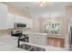 Bright kitchen with white cabinets, stainless steel appliances, and a chandelier in the dining area at 18840 Silver Quay Dr # 12, Cornelius, NC 28031