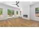 A modern living room boasting hardwood floors, a fireplace, windows and sliding glass door at 2004 St John St, Charlotte, NC 28216