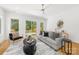Contemporary living room with gray sofa, stylish decor, and hardwood floors at 2004 St John St, Charlotte, NC 28216