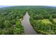 An aerial view of a wide river surrounded by lush green trees and beautiful houses at 2006 Sandy Pond Ln, Waxhaw, NC 28173