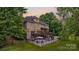 Beautiful backyard featuring a deck, patio, pool, and fenced yard surrounded by lush greenery at 2006 Sandy Pond Ln, Waxhaw, NC 28173