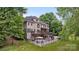 Expansive backyard featuring a deck, outdoor seating, and mature trees for privacy at 2006 Sandy Pond Ln, Waxhaw, NC 28173