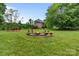 Backyard with a fire pit and benches, perfect for outdoor gatherings at 2006 Sandy Pond Ln, Waxhaw, NC 28173
