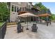 Enjoyable backyard patio with chairs and an umbrella, perfect for outdoor relaxation at 2006 Sandy Pond Ln, Waxhaw, NC 28173