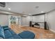 Finished basement featuring a home theater, wet bar, and comfortable blue sectional seating at 2006 Sandy Pond Ln, Waxhaw, NC 28173