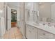 Bathroom vanity features white cabinets, a mirror, and tiled flooring at 2006 Sandy Pond Ln, Waxhaw, NC 28173